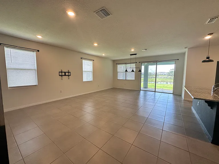 Living area with view of lanai and pond.