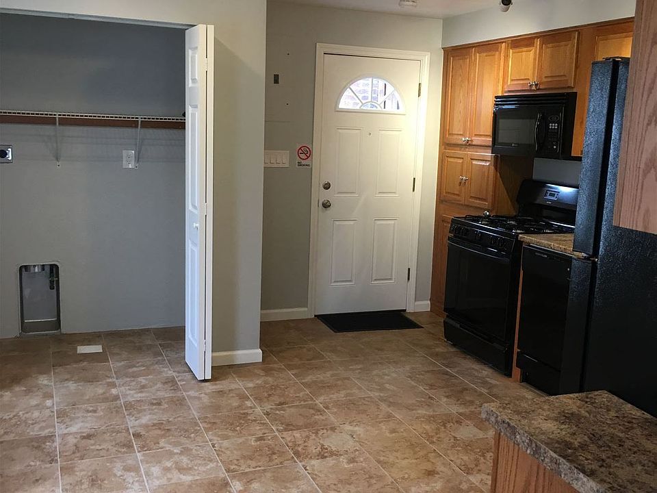 Kitchen with front door and laundry hookup.