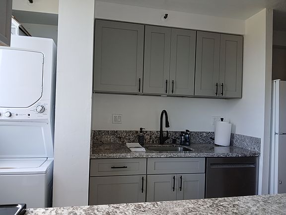 New countertop, cabinets, sink, dishwasher, plus washer/dryer. Sneak peak of the refrigerator/freezer.