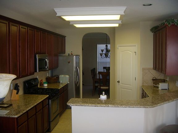 Granite and dark wood with tile backsplash in kitchen