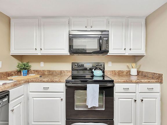Roomy Kitchen with Granite-Style Counters and Black-on-Black Appliances