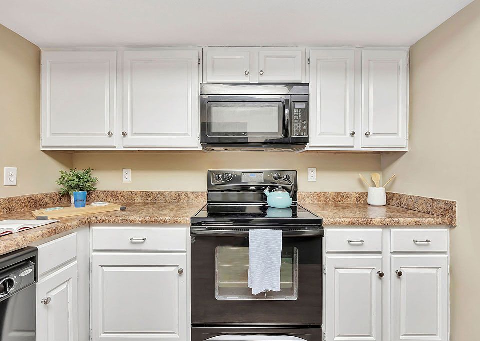 Roomy Kitchen with Granite-Style Counters and Black-on-Black Appliances