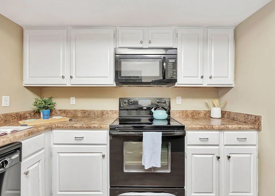 Roomy Kitchen with Granite-Style Counters and Black-on-Black Appliances