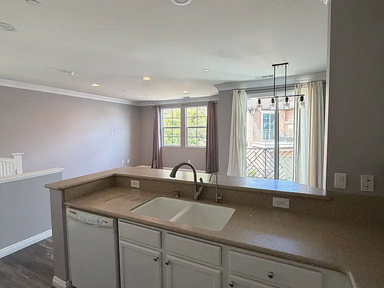 Kitchen opens seamlessly to the living and dining areas.
