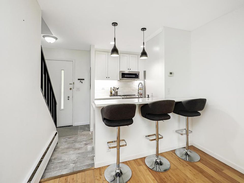 Breakfast bar with space for up to three people. Also space for a dining room table between kitchen and living room.
