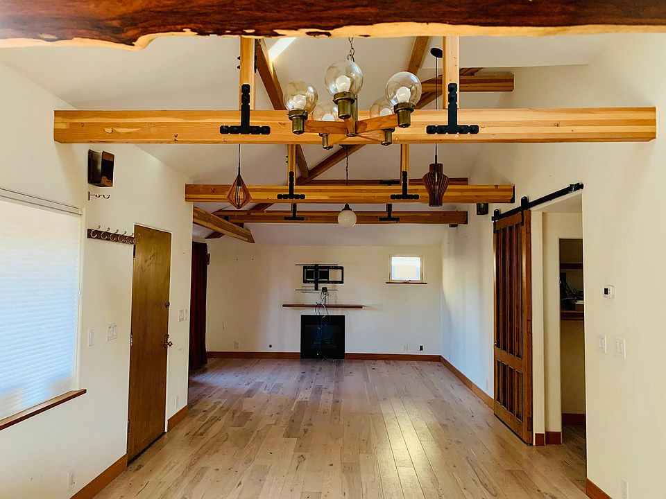 View from kitchen to living room with gas fireplace and built in hdmi wiring to media closet.