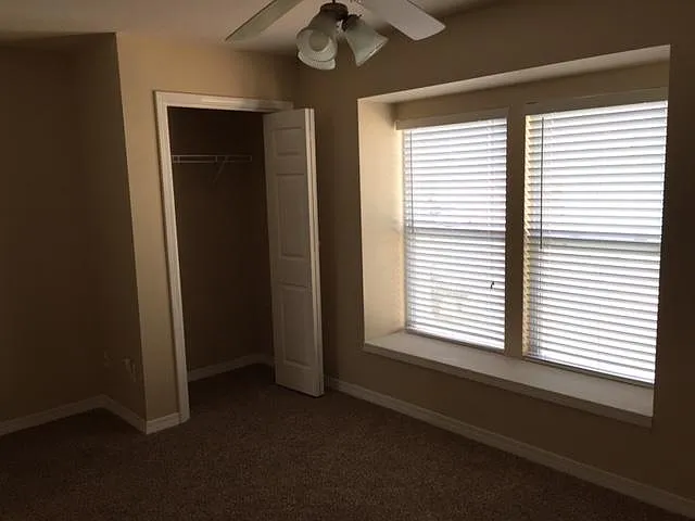 The second spacious bedroom serves as a versatile guest room, kids space, or home office.