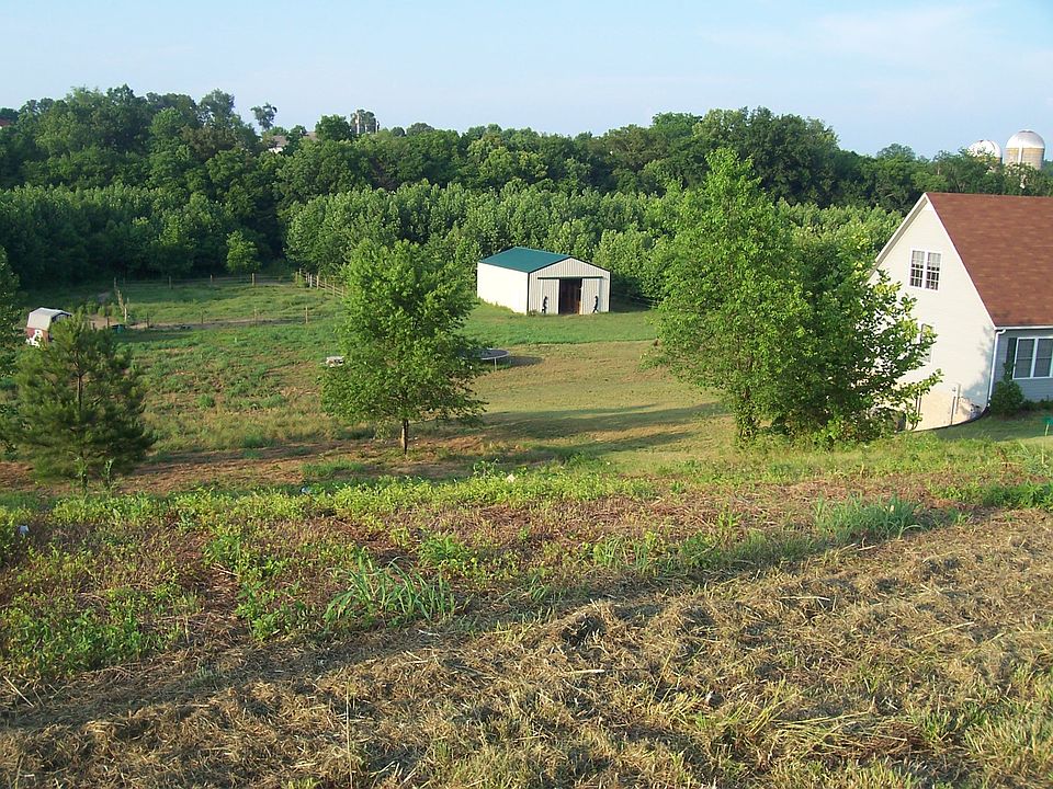 Lot on West side also for sale.  This is view of the barn, and side of house