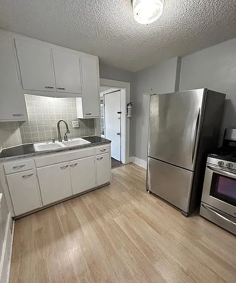 Kitchen with stainless steal appliances, new laminate flooring, freshly painted walls. Plenty of storage.