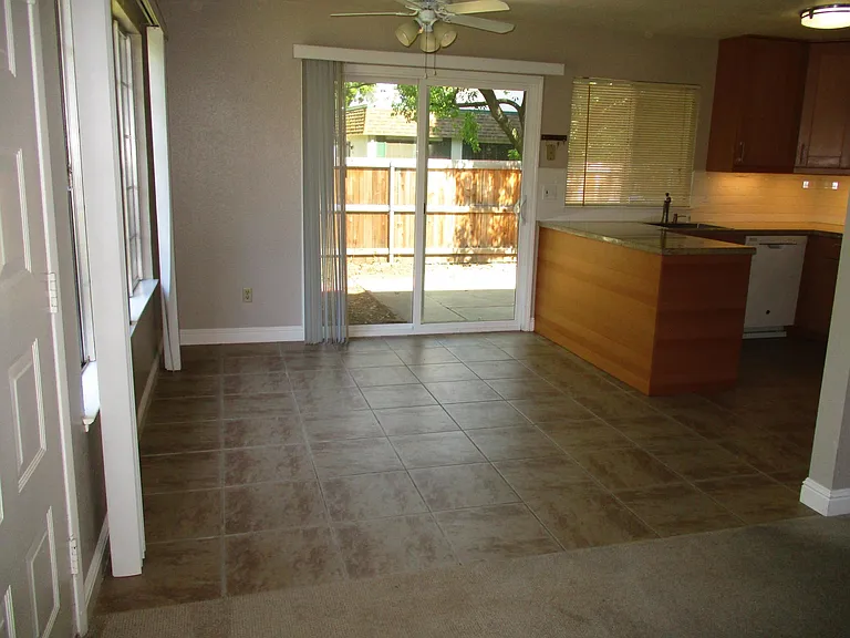 Dining area overlooks spacious patio, kitchen and greenbelt. Lots of natural light in home