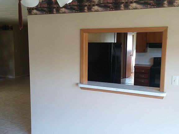 Dining room view of front entrance and kitchen