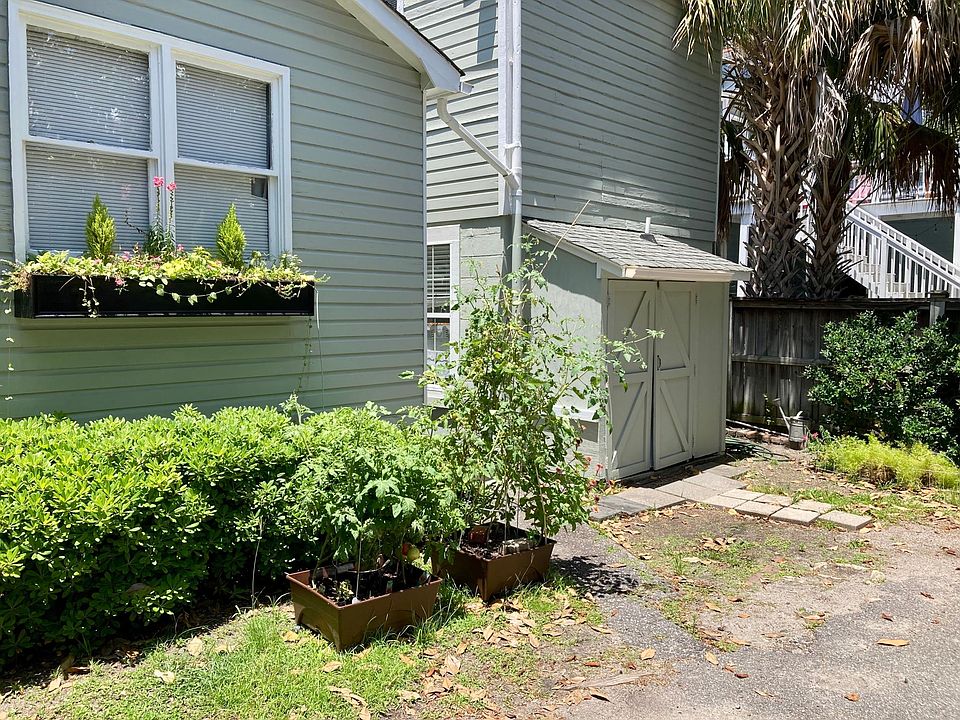 The back of the house where parking for one car is available. This side receives morning sun good for gardening.