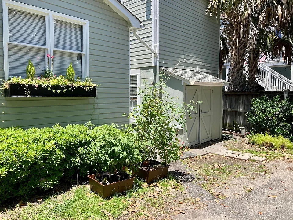 The back of the house where parking for one car is available. This side receives morning sun good for gardening.