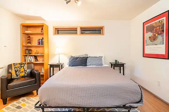 Downstairs bedroom with sitting area and bookshelf. Always nice and cool with options to heat if chilly