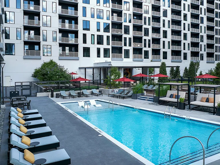 Resort-style swimming pool with expansive sundeck and cabanas