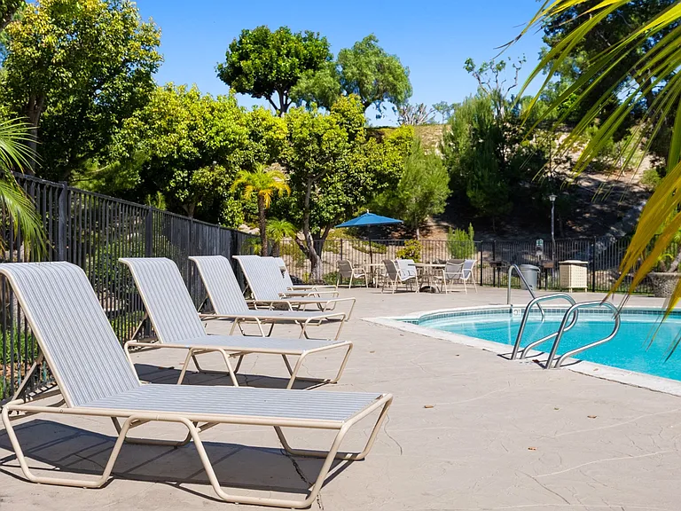 Pool-side lounge chairs at River Oaks in Oceanside, CA