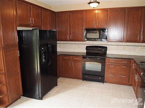 U shaped kitchen offers plenty of countertop and is furnished with all appliances.