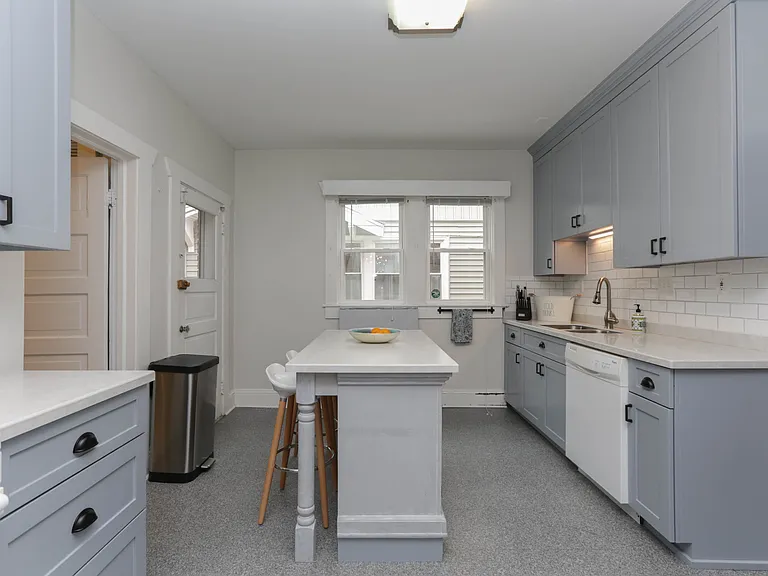 Quartz countertops and tile backsplash