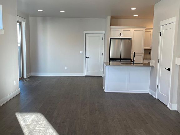 Living room, dining area and kitchen to the right; view from front door area