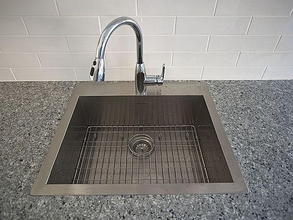 Stainless steel sink with deep single bowl and pull out sprayer faucet