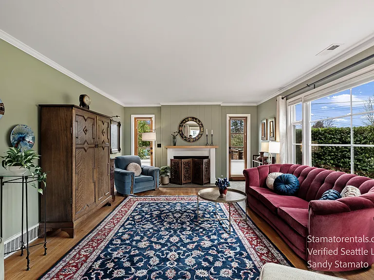 Comfortable gathering space with abundant natural light. French doors open up to your extended outdoor living. Decorative fireplace (non working)
