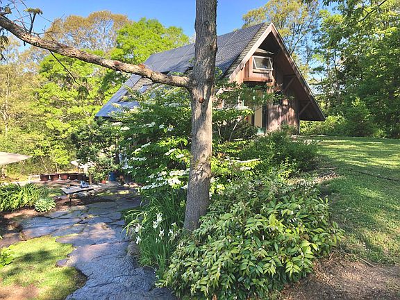 Southeast corner of house with slider to upper yard.