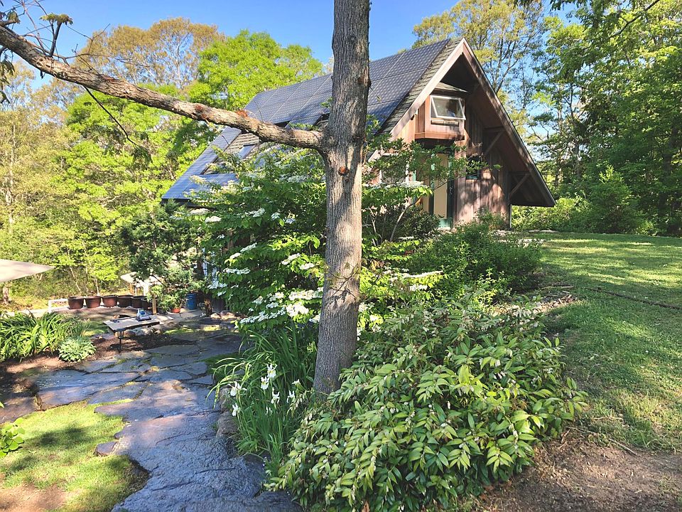 Southeast corner of house with slider to upper yard.