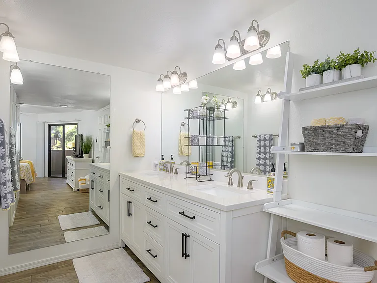 Updated bright bathroom with raised dual vanity.