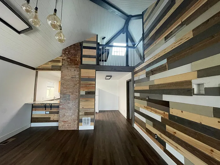 Livingroom side view into kitchen - 200 year old chimney is a gorgeous talking point!