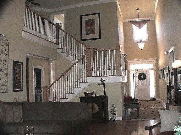 Dramatic staircase opens to GR & Balcony