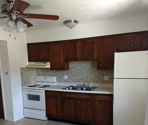 KITCHEN COMES WITH STOVE AND REFRIGERATOR. KITCHEN HAS EXTRA STORAGE UNDER STEPS