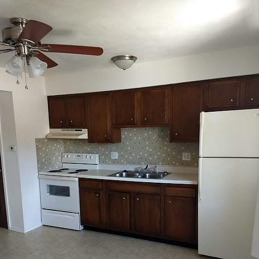 KITCHEN COMES WITH STOVE AND REFRIGERATOR. KITCHEN HAS EXTRA STORAGE UNDER STEPS