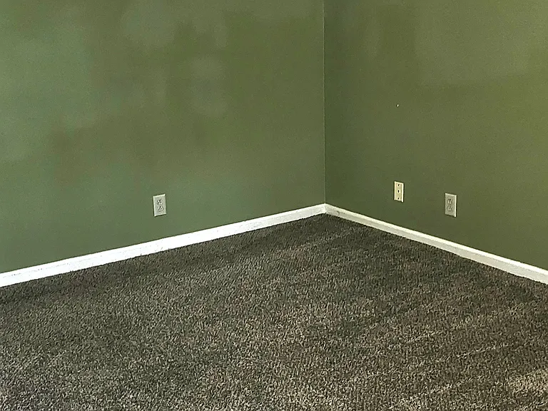 The large bedroom at back of the condo has a window overlooking the woods, walk-in closet and attached half bath.