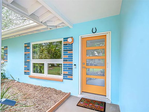 Hurricane-rated front door and windows in main block of house. Front door features invisible screen door.