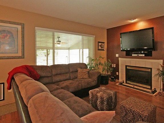 Large family room with gas fireplace and designer paint.