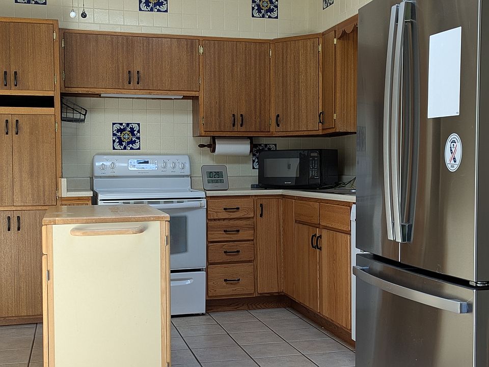 Full kitchen with new refrigerator.