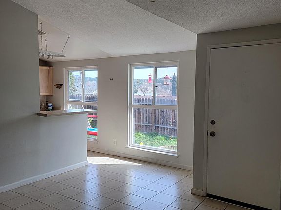 Dining room. Tile floor. Front door .
