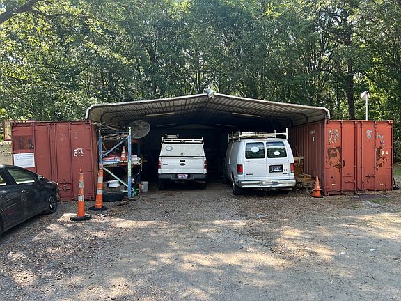 Shed with 2 of the 3 metal 40 foot containers.
