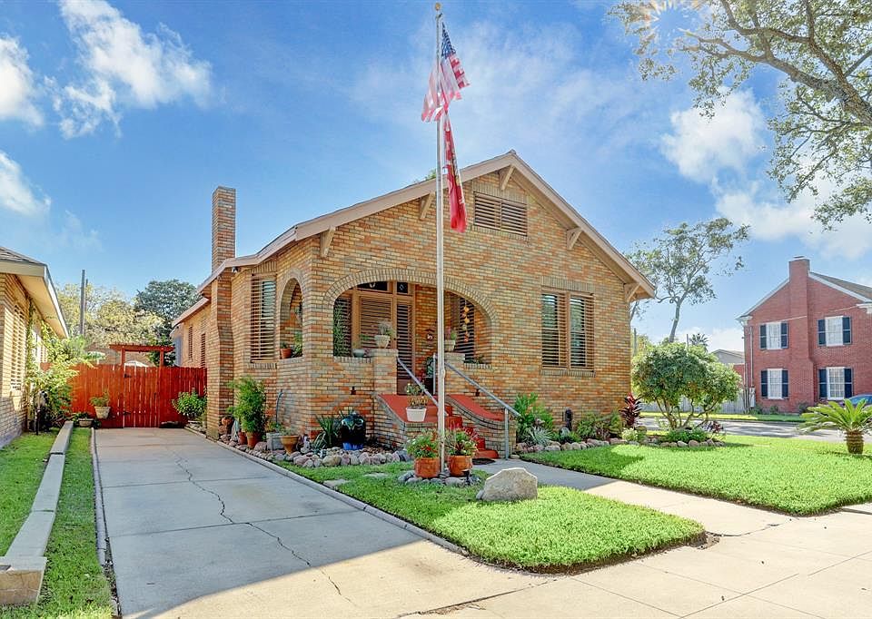 Circa 1939, Craftsman-style brick bungalow with off-street parking driveway on the left.