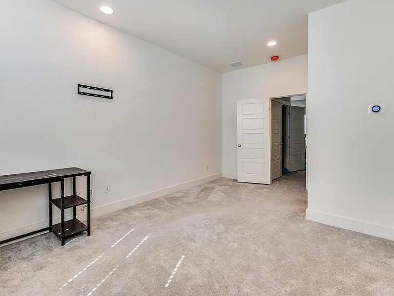 Master bedroom with ceiling fan and lots of natural sunlight (desk has been removed.)
