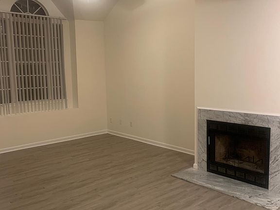 Living room with fireplace and ceiling fan