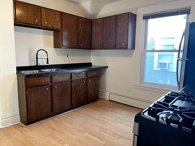 Updated cabinets with stainless sink and spray faucet