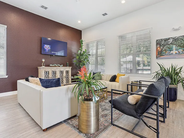 Chic and modern living room with stylish furniture, indoor plants, and contemporary decor in a sunlit space.