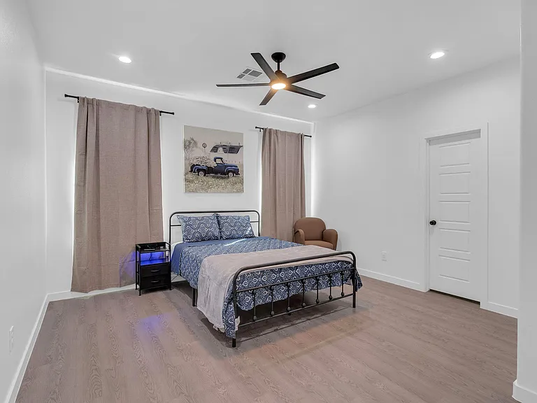 Comfy Queen Bed, nightstand and couch. Bathroom Door Closed