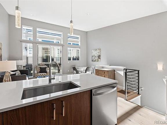 Open living/dining/kitchen with large windows