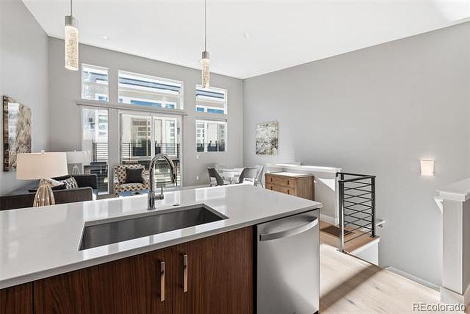 Open living/dining/kitchen with large windows