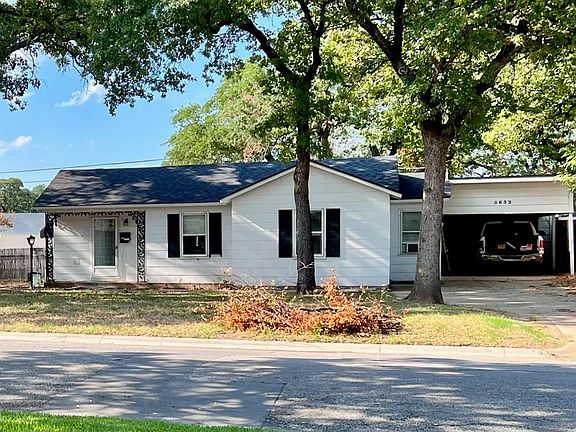 Front view of home, carport and one car garage