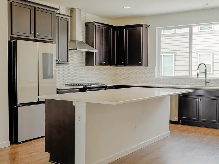 Chef inspired kitchen with oversized island, high end stainless steel appliances and Samsung Smart Hub Fridge