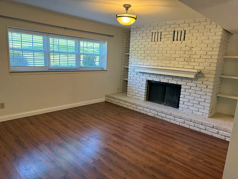 Den with woodburning fireplace