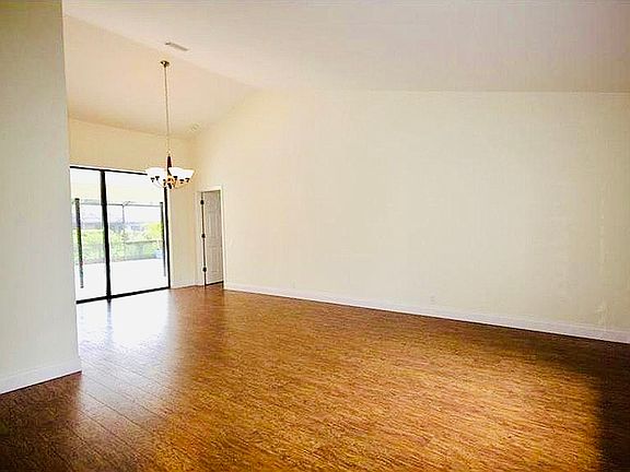 Entryway, seating room and view of dining room